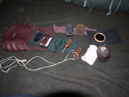 In my belt pouch I carry my sewing and fire starting kits as well a sling, small mirror, cloth bandages and some salves and iodine