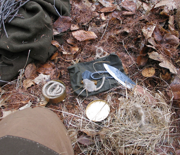 A basic flint-and-steel kit with char cloth and tow.